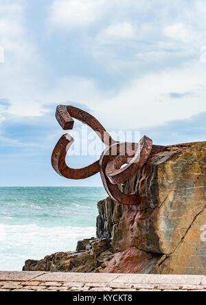 Sculpture The Comb of the winds in San Sebastian , Spain during stormy weather with scenic waves crushing upon stones Stock Photo