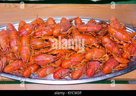 Red boiled crawfishes on the table in oval dish Stock Photo