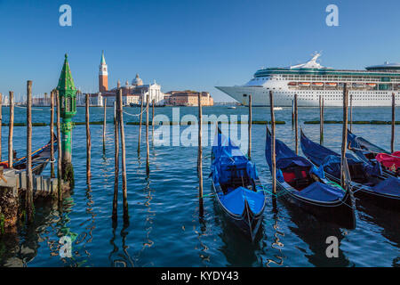 The Royal Caribbean cruise ship Rhapsody of the Seas and gondolas in Veneto, Venice, Italy, Europe. Stock Photo