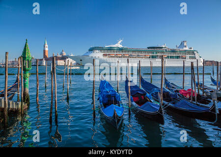 The Royal Caribbean cruise ship Rhapsody of the Seas and gondolas in Veneto, Venice, Italy, Europe. Stock Photo