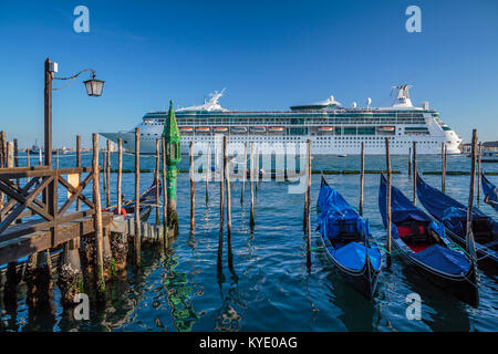 The Royal Caribbean cruise ship Rhapsody of the Seas and gondolas in Veneto, Venice, Italy, Europe. Stock Photo