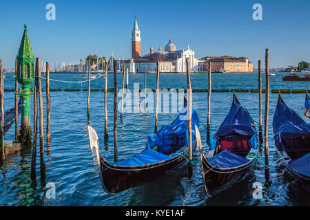 Parked gondolas and the Church of San Giorgio Maggiore in Veneto, Venice, Italy, Europe, Stock Photo
