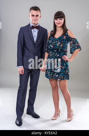 Happy teenage couple in full length studio shot Stock Photo
