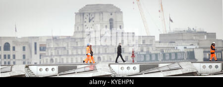 Tom Cruise (centre) walks along Blackfriars Bridge in London, during filming for Mission Impossible 6. Stock Photo