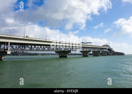 Auckland Harbor Bridge under a cloudy blue sky in downtown Auckland, New Zealand, October 11, 2017. () Stock Photo