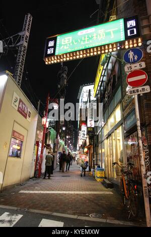 People walk through the Omoide Yokocho (Memory Lane) area of Shinjuku, Tokyo, Japan at night, an area known for its nightlife and bar scene, October 24, 2017. () Stock Photo