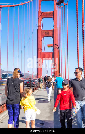 SAN FRANCISCO, CA- Oct.11, 2015: Golden Gate Bridge parents and kids shown walking across the span on the pedestrian lane. Popular activity. Sunny day Stock Photo