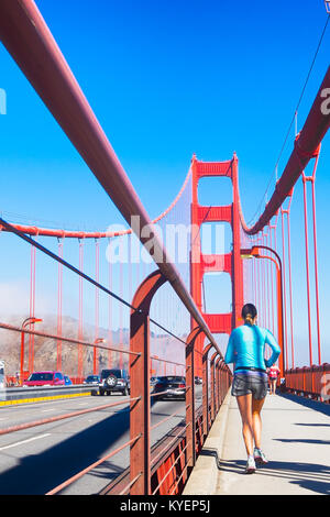 SAN FRANCISCO, CA- Oct. 11, 2015: Golden Gate Bridge jogger on the pedestrian lane. Low angle point of view. Copy space. Stock Photo