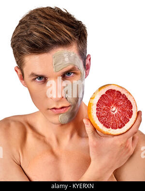 Facial man mask from fruits and clay . Face mud applied. Stock Photo