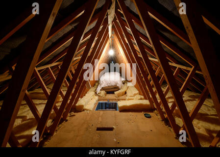 Interior of a domestic loft space showing the roof structure together with boarding and insulation Stock Photo