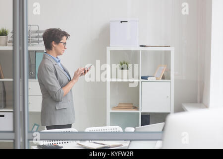 Young caucasian woman sending message using smartphone over isolated ...