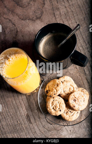 Cofe and orange juice in morning, abstract food background on dirt wooden texture Stock Photo
