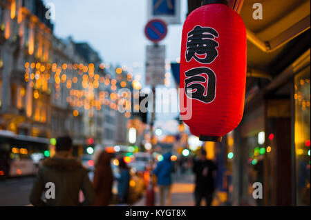 Red japanese lantern outside a restaurant in Luxembourg ville with bokeh lights Stock Photo