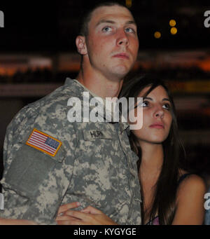 Pvt. 1st Class Brandon Hern of the 223rd Military Police Company stationed in Louisville, Ky. and guest Leanna Valla attend the USO Homefront Concert at the KFC Yum! Center in Louisville, Ky. July 26. The concert featured country music icons Eddie Montgomery and Troy Gentry of the duo Montgomery Gentry and was hosted by Poker After Dark hostess Leean Tweeden to show support for American troops deployed overseas.  (photo by Spc. David Bolton, Kentucky National Guard Public Affairs Office) Stock Photo