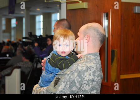 1st Lt. Wesley Newton holds his son during the Kentucky National Guard's Agribusiness Development Team 4  farewell ceremony at the Forks of Elkhorn Baptist Church in Midway, Ky. Jan. 3. The team will replace KY ADT 3 in Kandahar, Afghanistan in the coming weeks. (photo by Capt. Stephen Martin, Kentucky National Guard Public Affairs) Stock Photo