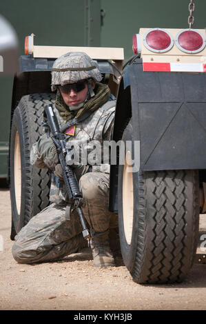 Senior Airman Beau DeLeon, a civil engineer from the New Jersey Air Guard’s 108th Contingency Response Group, takes cover during a simulated enemy attack at Joint Base McGuire-Dix-Lakehurst, N.J., on March 29, 2012. DeLeon was participating in an exercise called Eagle Flag, along with more than 80 Airmen from the Kentucky Air National Guard’s 123rd Contingency Response Group and about 50 active-duty Soldiers from the U.S. Army’s 690th Rapid Port Opening Element. (U.S. Air Force photo by Maj. Dale Greer) Stock Photo