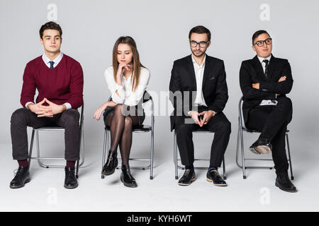 Group of people sitting on chairs waiting interviews Stock Photo