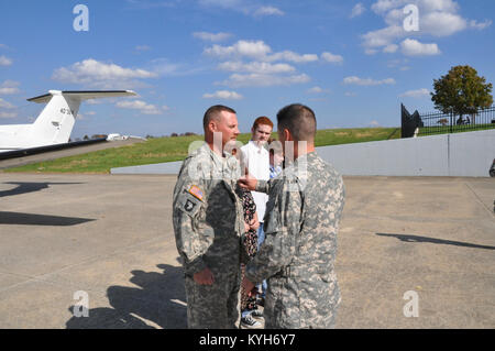 Chief Warrant Officer Five Stephen Hunnicut, commander of Detachment 11, Operational Support Airlift Command based out of Frankfort, Ky., gets promoted at Capital City Airport, Frankfort, Ky. Oct. 25, 2012. (photo by Capt. Stephen Martin, Kentucky National Guard Public Affairs) Stock Photo