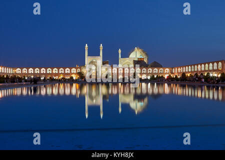 Isfahan, Iran - April 23, 2017: Night view of the pond with a fountain in the square Nagshe Jahan with reflection in the water of the Shah Abbas mosqu Stock Photo