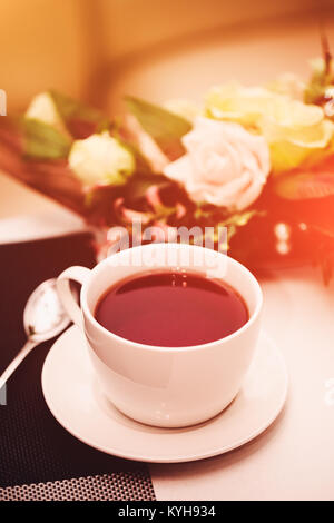Cup of tea on the table. Breakfast time. Food photo with flare. Stock Photo