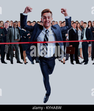 Happy businessman running through finishing line Stock Photo