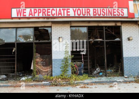 Atlanta, GA, USA - September 23, 2017:  A sign reading 'We appreciate your business' sits above a vandalized, burned out and abandoned business. Stock Photo