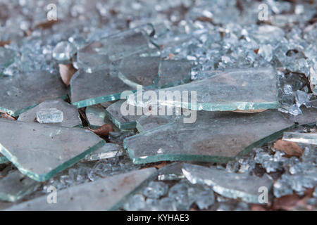 Pieces of broken glass lie on ground at building that has gone out of business Stock Photo