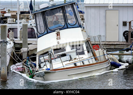 sinking pleasure boat at panama city marina. Looks as if the mooring ropes kept this boat from going under. Stock Photo