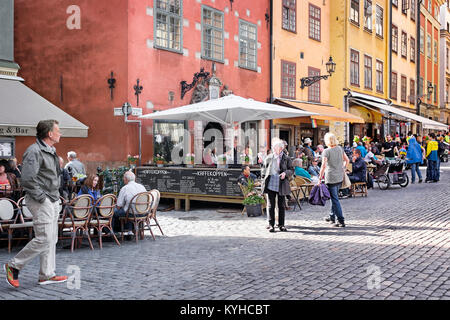 Stockholm Sweden busy sidewalk cafes in the picturesque historic neighborhood of Gamla Stan, or Old Town.The area is a popular tourist destination Stock Photo