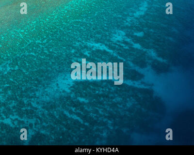 Drone photo of shallow coral reef in tropical blue water in Komodo National Park, Indonesia. Stock Photo