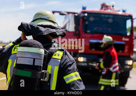 german fireman ( Feuerwehr ) stands near an accident Stock Photo