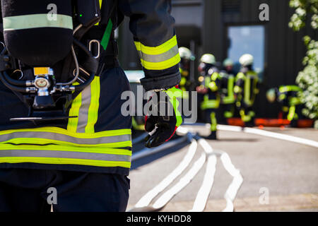german fireman ( Feuerwehr ) stands near an accident Stock Photo