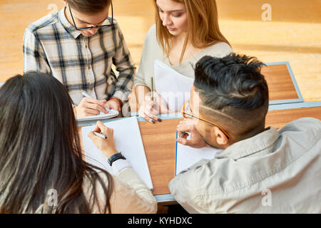 Multi-ethnic group of students studying together in lecture hall of modern college, high angle view Stock Photo
