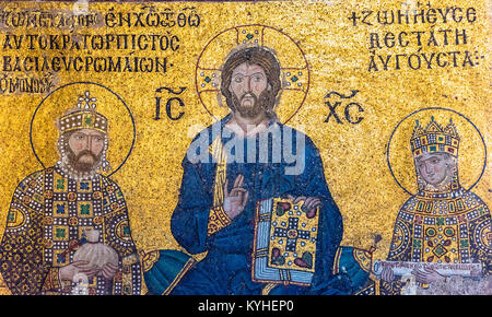 Byzantine mosaic of Jesus Christ is sitting on throne with Empress Zoe and Emperor Constantine IX Monomachus  in Hagia Sophia,Greek Orthodox Christian Stock Photo