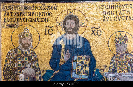 Byzantine mosaic of Jesus Christ is sitting on throne with Empress Zoe and Emperor Constantine IX Monomachus  in Hagia Sophia,Greek Orthodox Christian Stock Photo