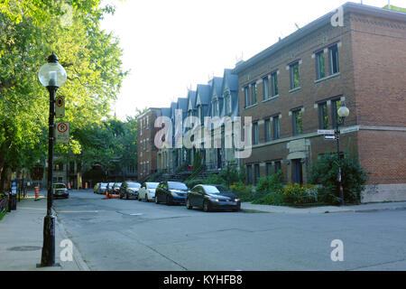 Parked cars in front of houses in Montreal. Stock Photo