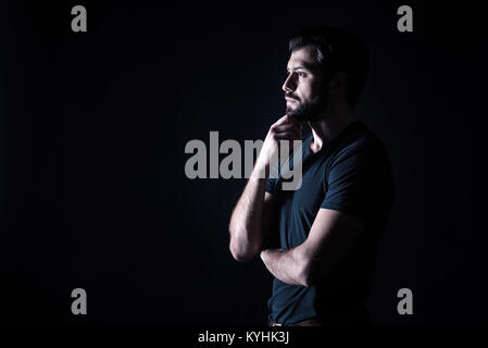 Nice thoughtful man holding his chin Stock Photo