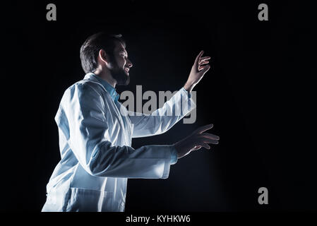 Nice happy scientist using virtual technology Stock Photo