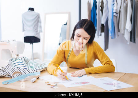 Enthusiastic creative worker drawing and smiling Stock Photo