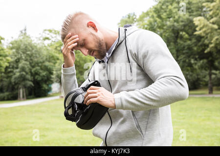 Male Looking Exhausted After 3d Experience Through Virtual Reality Headset Stock Photo