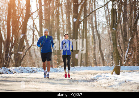Young sporty couple running in nature Stock Photo