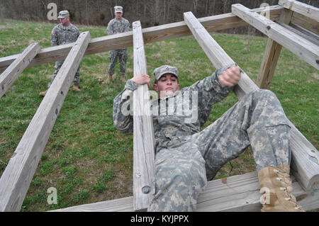 :  Kentucky National Guard new recruit Pvt. 1st Class Jacob Perkins of Crittenden, Ky., climbs through an obstacle during the Bravo Company Recruit Sustainment Program annual field training exercise at Grant County High School Junior Reserve Officer Training Corp complex in Dry Ridge, Ky. (Photo by Staff Sgt. Michael Oliver, Bravo Company Detachment of the 2/75th Recruiting and Retention Battalion) Stock Photo
