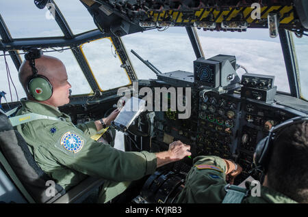 Lt. Col. Dave Flynn, a pilot for the Kentucky Air National Guard’s 165th Airlift Squadron, flies a Kentucky Air Guard C-130 Hercules in the skies of Alaska during a training scenario as part of Red Flag-Alaska on May 13, 2014. More than 100 Kentucky Airmen participated in the exercise from May 7 to 23. (U.S. Air National Guard photo by Master Sgt. Phil Speck) Stock Photo