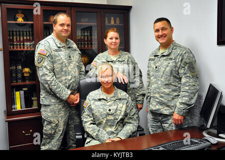 The Kentucky National Guard's Staff Judge Advocate General, Lt. Col. Natalie Lewellen (seated), (L-R) Capt. Spencer Robinson, Staff Sgt. Paulette Terry and Lt. Col. Jason Shepherd. The team works to provide legal counsel to the Kentucky Guard. (U.S. Army National Guard photo by Staff Sgt. Scott Raymond)