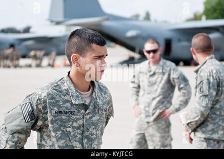 U.S. Army Pfc. Jonathon Hernandez, a paratrooper assigned to the Army's 173rd Infantry Brigade Combat Team stationed in Vicenza, Italy, collects his thoughts Sept. 5, 2014, as he prepares to board a Kentucky Air National Guard C-130 Hercules aircraft at Ramstein Air Base, Germany, in support of Operation Saber Junction. Hernandez's unit is participating in the operation with troops from 17 NATO countries. (U.S. Air National Guard photo by 2nd Lt. James W. Killen/Released)