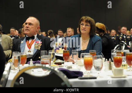 Kentucky National Guard State Command Sgt. Maj. Thomas Chumley and his wife, Wanda, enjoy the remarks made by Sgt. Maj. Gary Smith, 4th Marine Logistics Group command senior enlisted leader, at the 2015 Outstanding Airman and Soldier of the Year Banquet March 14, 2015 at the Kentucky Fair and Exposition Center in Louisville, Kentucky. Smith thanked the Wanda Chumley for her hospitality. The annual awards dinner honors Kentucky's finest Airmen and Soldiers who are recognized by their peers for dedicating themselves to the welfare and security of our nation. (Photo by Sgt. 1st Class Gina Vaile-N Stock Photo