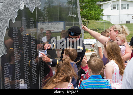 Col. Charles Jones traces the etching of his son’s name on the Kentucky National Guard Memorial during a dedication ceremony in Frankfort, Ky., May 25, 2015. The newly-dedicated monument honors the memory of more than 230 Kentucky Guardsmen who have lost their lives on duty since 1912, including Jones’ son, Sgt. 1st Class Charles Jason Jones who died in Iraq in 2006. (U.S. Army National Guard photo by Staff Sgt. Scott Raymond) Stock Photo