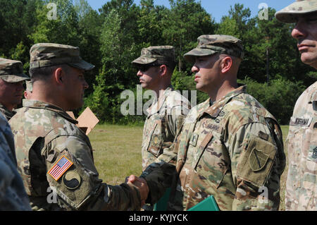 1st Lt. Chris Galvan (right), assigned to 1st Battalion 149th Infantry Regiment, Kentucky National Guard, receives an Army Achievement Medal from the Commander of the 116th Infantry Brigade Combat Team Col. Scott Smith for his efforts as cadre and planning officer for the Expert Infantry Badge where testing lasted Aug. 5 through Aug. 10 at Fort Pickett, Va. Stock Photo