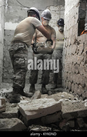 Airmen from the Kentucky Air National Guard’s 123rd Civil Engineer Squadron in Louisville, Kentucky, remove stone and brick work from the kitchen of Special School #12 in Chisinau, Moldova, June 5, 2016. More than 35 Airmen from the unit are renovating the institution, which is the only school in Moldova specifically for deaf and special-needs students. The humanitarian project is a partnership with the Office of Defense Cooperation and U.S. European Command, with funds being provided by the National Guard Bureau. (U.S. Air National Guard photo by Tech. Sgt. Vicky Spesard) Stock Photo