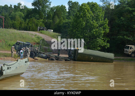 Soldiers of the 2061st Multi Role Bridge Company recover an interior bay of an improved ribbon bridge with a M1977 Common Bridge Transporter (CBT) as part of their annual training at Fort Knox Kentucky on 15 Jul 2016. (Kentucky National Guard photo by Walt Leaumont) Stock Photo